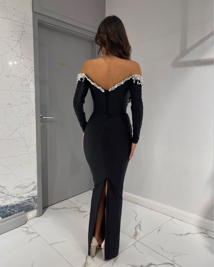 NOIR MYSTIQUE zwarte off-shoulder avondjurk achterkant